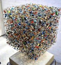 a cube made of colored wires on top of a table