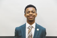 a young man wearing a suit and tie